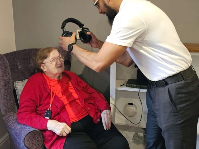 Aadil performs small hearing tests with Elm Bank Residents