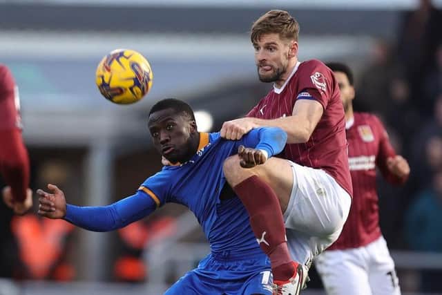 Jon Guthrie battles for the ball with Shrewsbury striker Dan Udoh at Sixfields on Saturday (Photo by Pete Norton/Getty Images)
