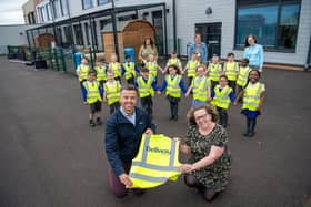 •	Bellway Sales Manager Andrew Odams, with Head of School Sarah Whitlock and youngsters posing with their hi-vis jackets