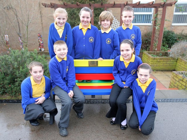 Children from year 6 at Whitehills Primary School sitting on a friendship bench which has been installed in memory of Imogen Wright, who died last summer of a brain tumor.