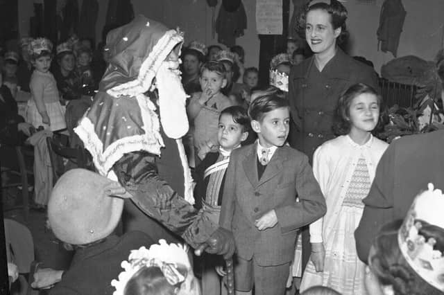 Father Christmas visit to children with Cow and Gate hats