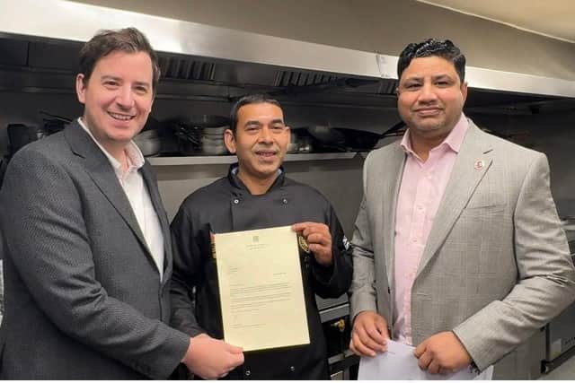 Abdul Hye being presented with a letter by Mike Reader MP with Naz Islam