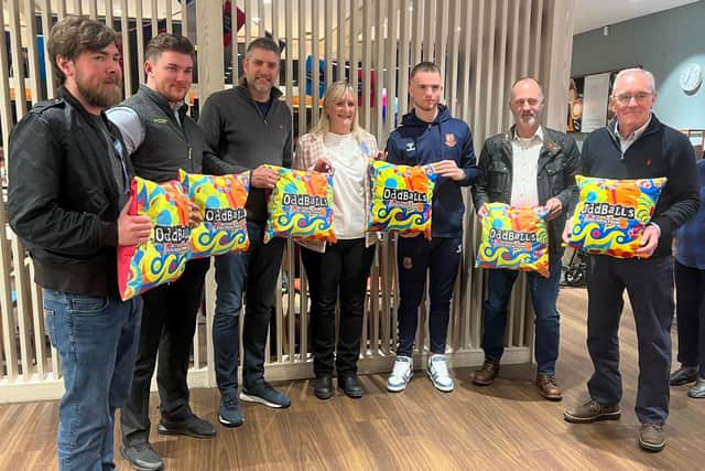 Organiser Marion Chown, Northampton Town Football Club midfielder Marc Leonard to her right, and a number of employees from Waitrose in Harborough Road.