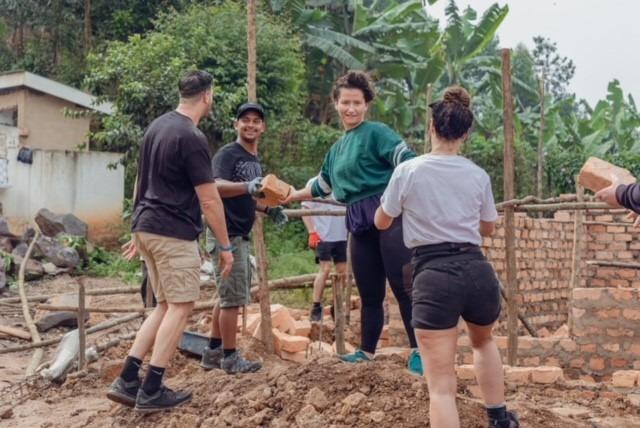 Bellway site manager Ross Jenkins and other volunteers creating the framework for two extra classrooms at the school.