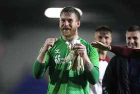 Cobblers goalkeeper Lee Burge celebrates with the Cobblers supporters after Tuesday's win at AFC Wimbledon (Picture: Pete Norton)