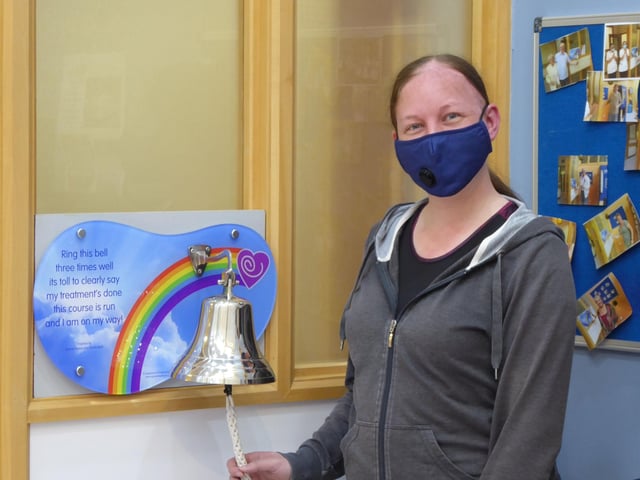 Cat Heald ringing the bell after completing her brain cancer treatment