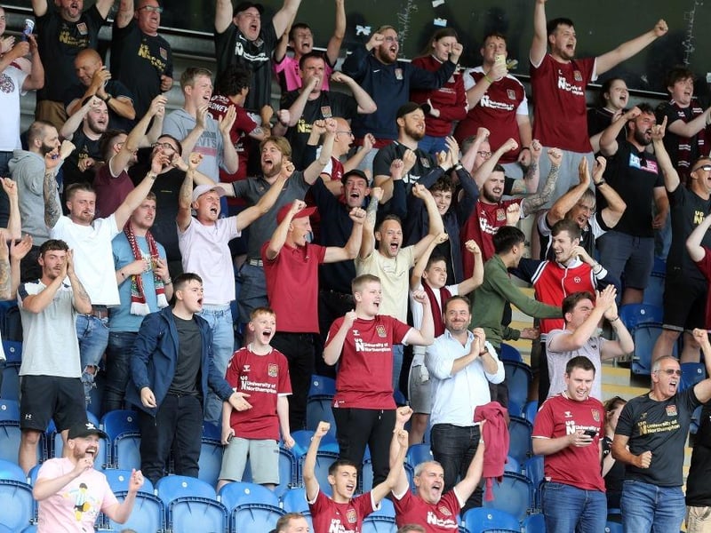 Northampton Town fans celebrate victory at the final whistle during the Sky Bet League Two match between Colchester United and Northampton Town on August 14, 2021.