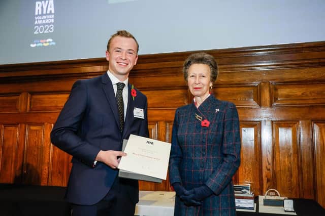 Henry Avery from Hollowell SC is presented an RYA Volunteer Award by HRH The Princess Royal