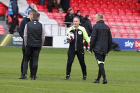 Referee Robert Lewis inspects the pitch at Moor Lane before kick-off.