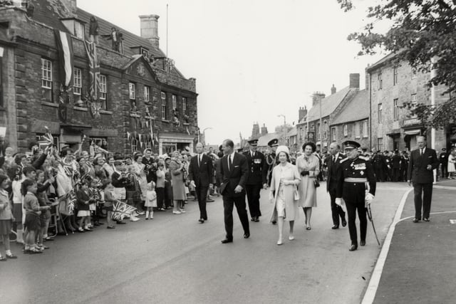 The Queen and Duke of Edinburgh walk through Higham Ferrers during their trip to Northamptonshire on July 9, 1965