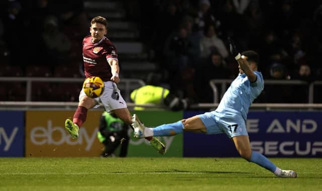 An airborne Sam Hoskins delivers a cross into the box.