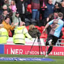 Sam Hoskins sprints towards the away fans after scoring his 20th goal of the season.