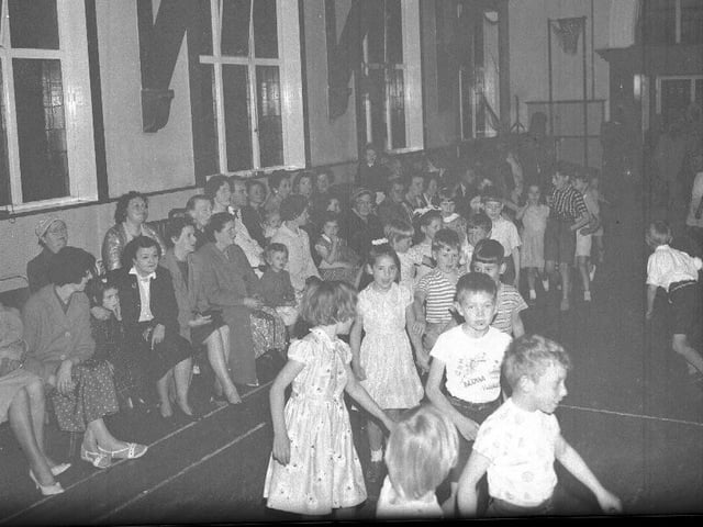 Children playing games in large hall
