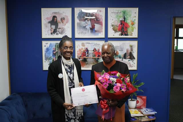 Marcia receiving her award from Morcea MBE DL