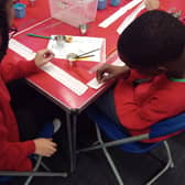 Children taking part in a growing activity at Spring Lane Primary School