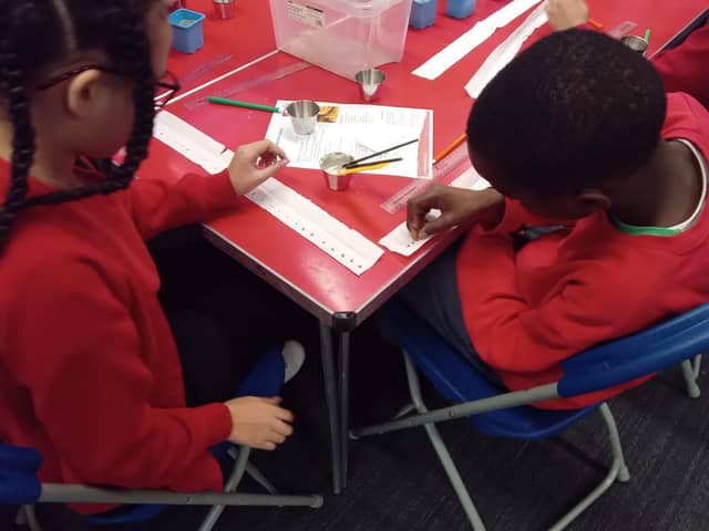 Children taking part in a growing activity at Spring Lane Primary School