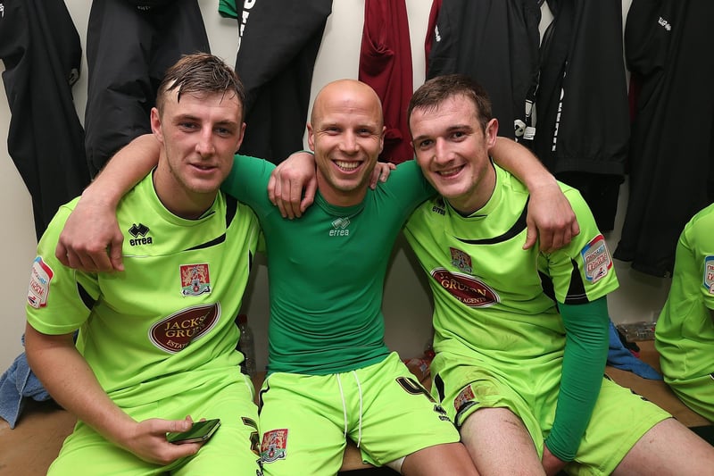 Northampton Town goal scorer Luke Guttridge (C) celebrates with team-mates Lee Collins and John Johnson in the changing room after the npower League Two Play Off Semi Final Second Leg between Cheltenham Town and Cobblers on May 5, 2013.