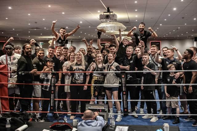 The Team Shoe-Box fighters, coaches and supporters face the camera following Sunday's boxing show at the Park Inn Hotel