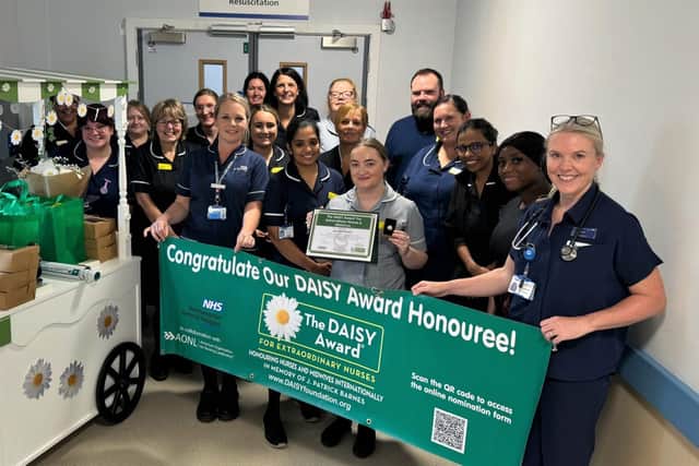 Lauren Head with her award and her team.