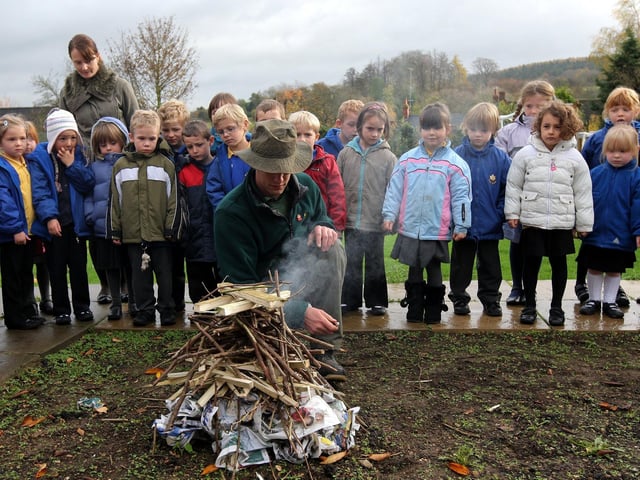 Countryside Rangers from Daventry Country Park visiting Badby Primary School to make soup with the pumpkins from the school garden and to make a bonfire.  Pictured: Countryside Ranger Matty Jones lighting the bonfire.