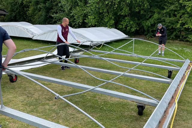 Grange Park Cricket Club members fix the broken steel frames