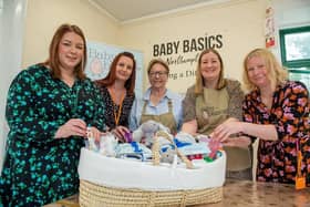Members of the Baby Basics team showing Christina Wilkinson the goods they supply to new mothers