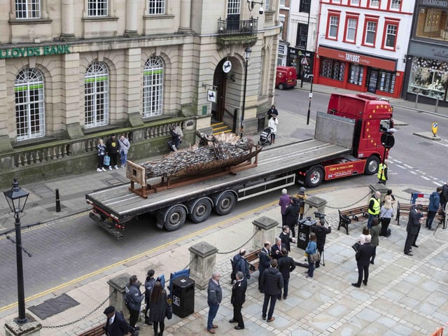 A few hardy souls braved the chill to see the stature's arrival in town