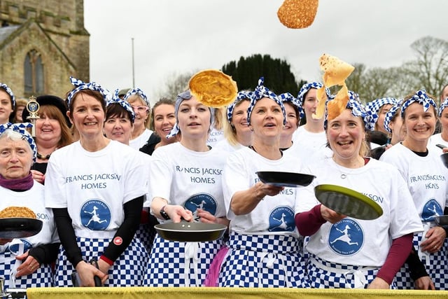 The ladies had to remember to toss their pancakes as they ran