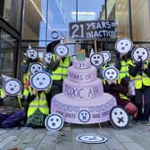Campaigners “celebrated” with music, party hats and a giant “21 Years of Toxic Air” cake.