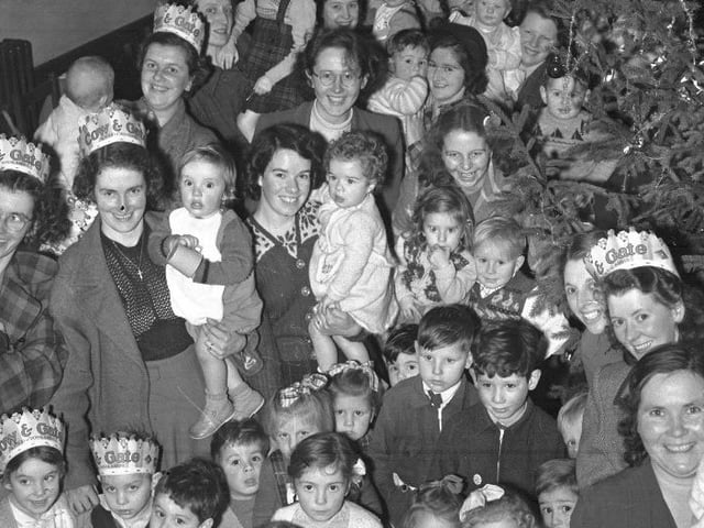 Children and mums with Cow and Gate hats and Christmas tree