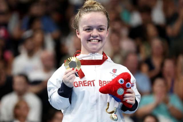 Gold medalist Maisie Summers-Newton of Team Great Britain celebrates on the podium at the Para Swimming Women's 100m Breaststroke - SB6 Medal Ceremony (Photo by Sean M. Haffey/Getty Images)
