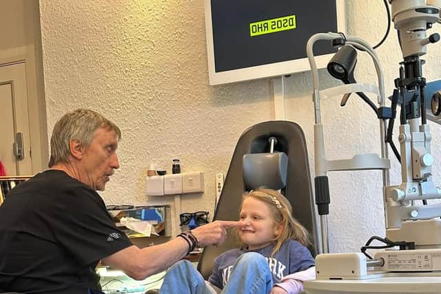 Brian Tompkins with a young patient at his practice in Northampton. Photo: TK&S Optometrists