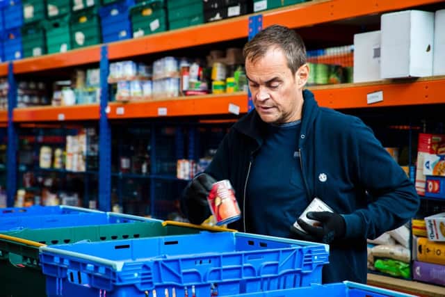 Volunteer packs food at Northampton Hope Centre Distribution Warehouse