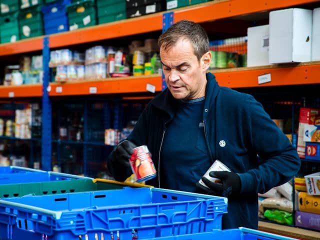 Volunteer packs food at Northampton Hope Centre Distribution Warehouse