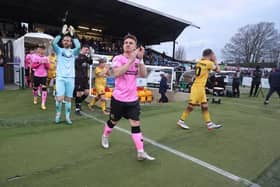 Sam Hoskins leads the Cobblers out as captain in Jon Guthrie's absence