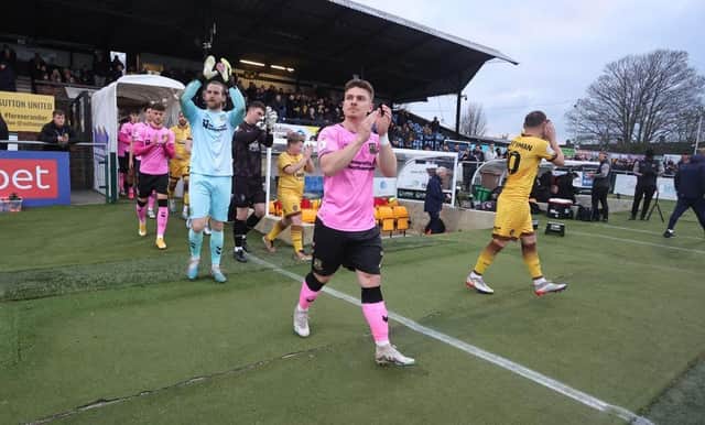 Sam Hoskins leads the Cobblers out as captain in Jon Guthrie's absence