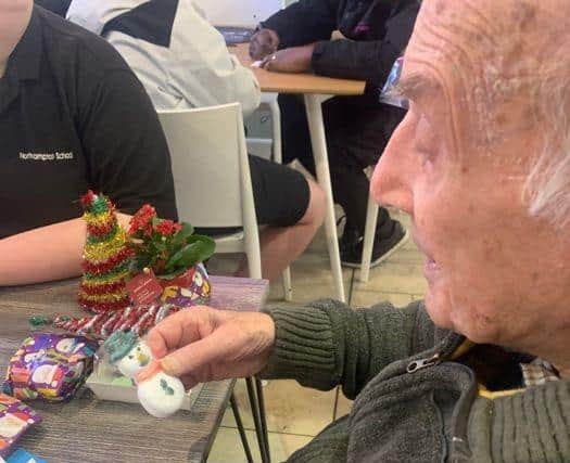 Local resident Wally and students from Cambian Northampton School exchanged gifts.