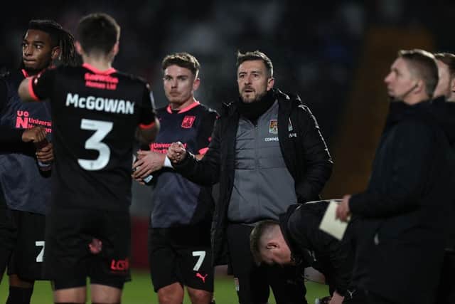 Jon Brady speaks to his players during Tuesday's game against Stevenage