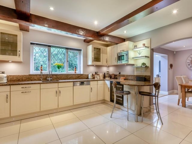 A modern, open-plan kitchen leads out to a breakfast room and is a sociable space to entertain while cooking