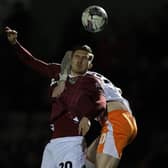 Cobblers defender Harvey Lintott battles for the ball in the Sixfields clash with Blackpool on Tuesday night (PIcture: Pete Norton)