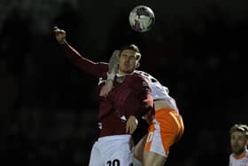 Cobblers defender Harvey Lintott battles for the ball in the Sixfields clash with Blackpool on Tuesday night (PIcture: Pete Norton)