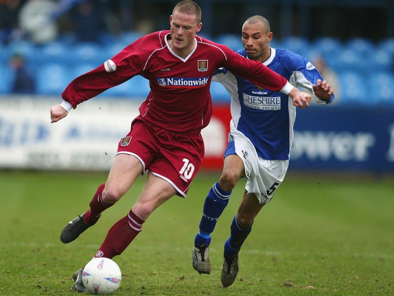 Josh Low of Northampton Town takes the ball past Karl Munroe of Macclesfield Town during the Nationwide League Division Three match between Macclesfield Town and Northampton Town held on March 27, 2004 at Moss Rose, in Macclesfield, England. Northampton Town won the match 4-0. (Photo by Pete Norton/Getty Images)