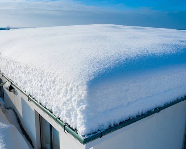Heavy snow on a flat roof can cause structural damage.