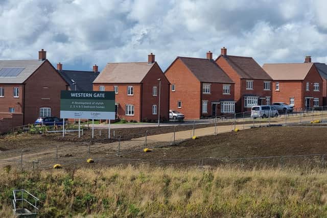The huge 5m x 6m marketing billboard at Western Gate, erected right next to homes on Rowan Close, which residents say blocks their views and makes the estate look “disgraceful.”