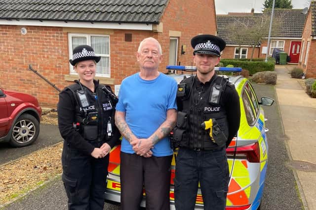 Police officers with victim of the crime after his wallet was returned to him.