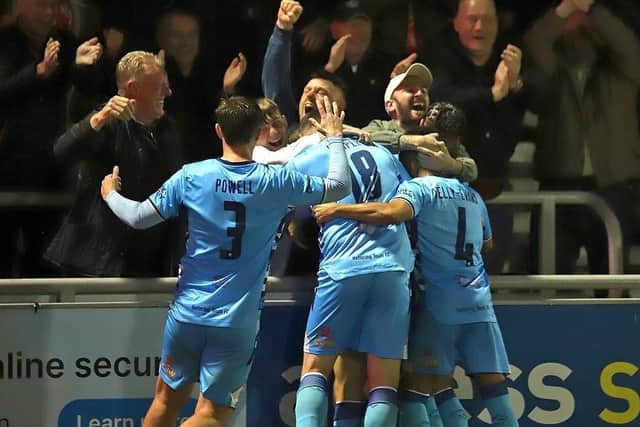 Kettering players and supporters celebrate Luca Miller's equaliser against the Cobblers (Picture: Peter Short)