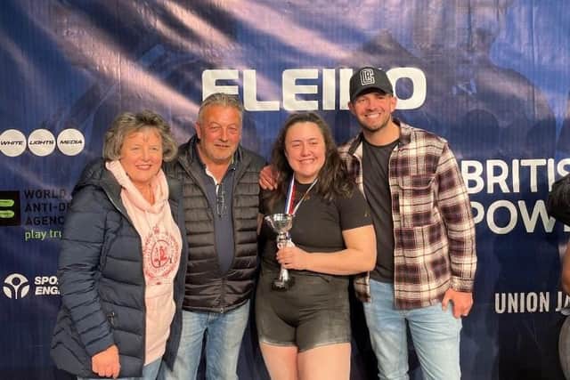 Harriet Waite collecting her British Junior Championship trophy with mum Julia, dad Kevin and brother Sam