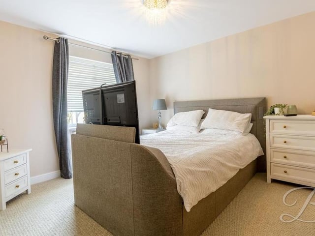 And so we move on to the four bedrooms. This is the master, which has a carpeted floor, window facing the front of the house and en suite facilities.