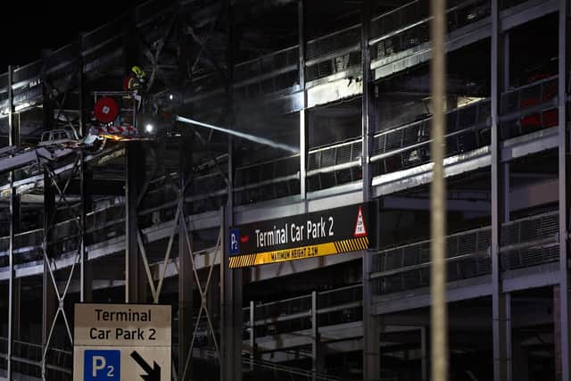 Firemen battle a fire at London's Luton Airport car park. Photo by HENRY NICHOLLS/AFP via Getty Images