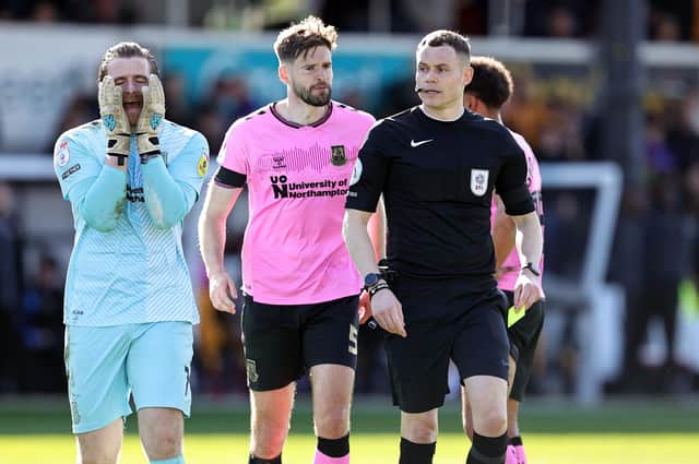 Lee Burge's expression just about sums up a miserable day for the Cobblers in Wales.